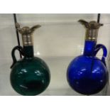 2 coloured glass decanters with silver coloured mo