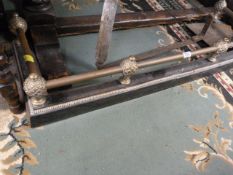 Brass and iron fender and a peat cutter