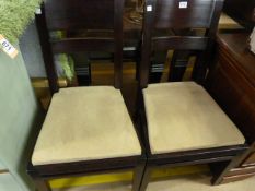 Pair of dark wood dining chairs with cream suede s