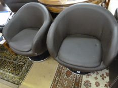 A pair of brown leather swivel tub chairs