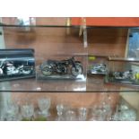 Four cased models of motorbikes including Harley D