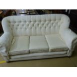 A White upholstered two seater settee