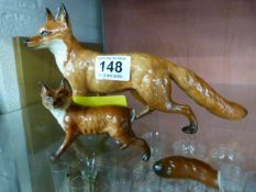 Two Beswick foxes in various poses