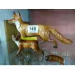 Two Beswick foxes in various poses