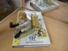 Royal Doulton Winnie the Pooh and Christopher Robin figure group and a book