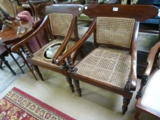 A pair of unusual mahogany chairs with wicker seats