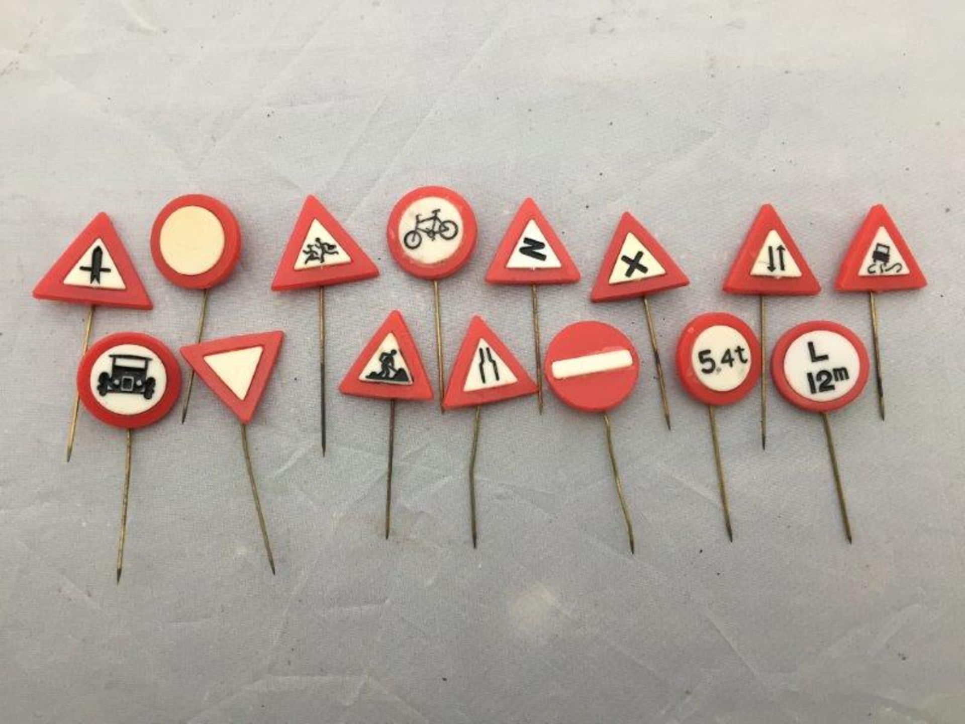 A collection of 15 road sign stick pins.