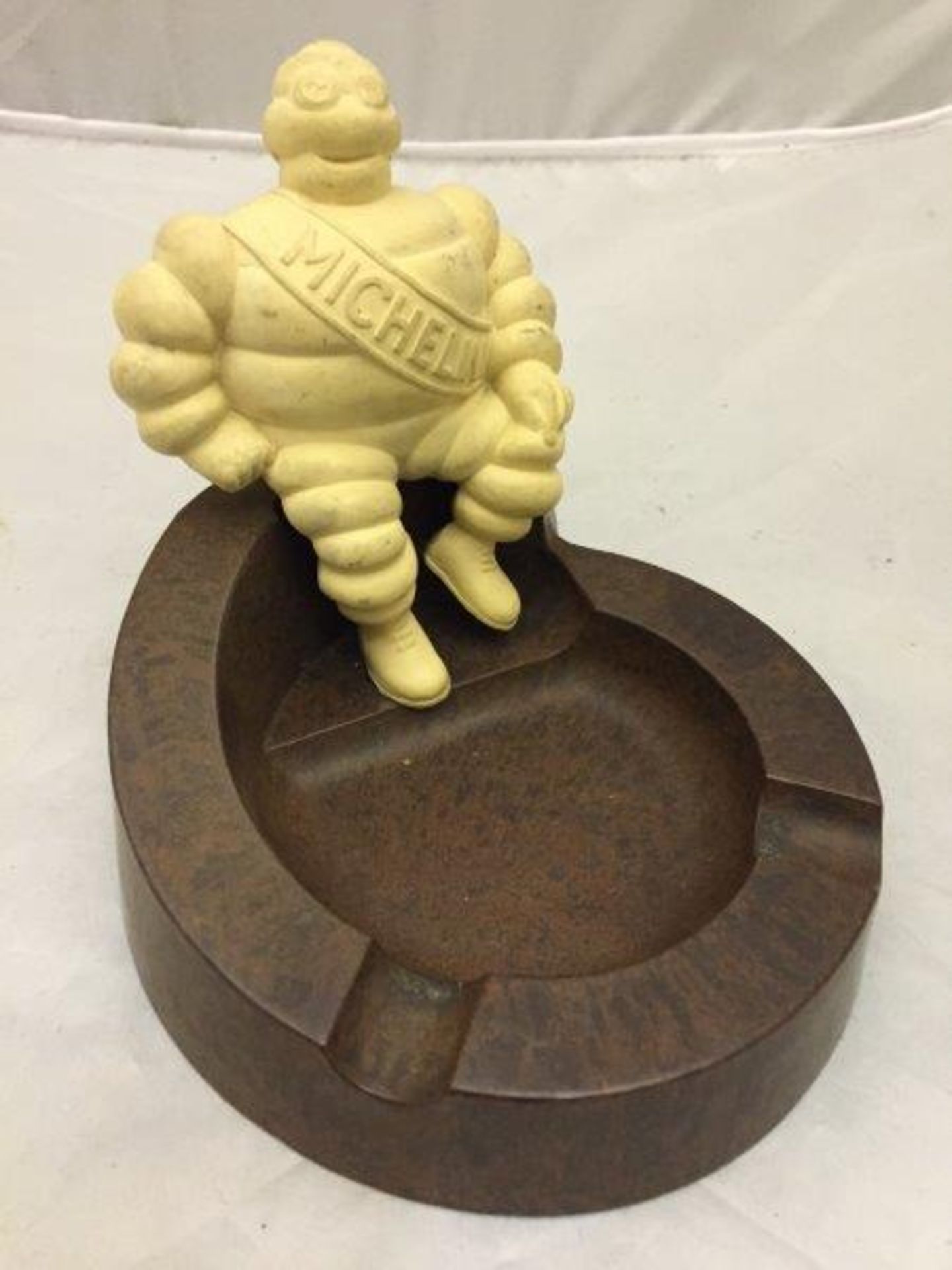 A Michelin bakelite ashtray surmounted by a figure of Mr. Bibendum.
