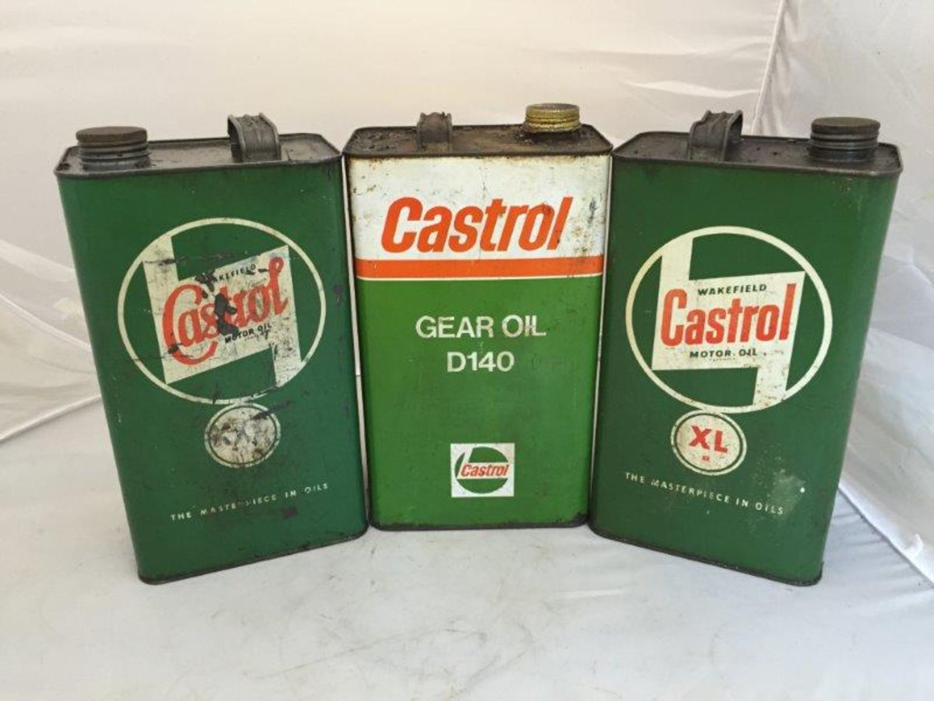 Three Castrol gallon cans.