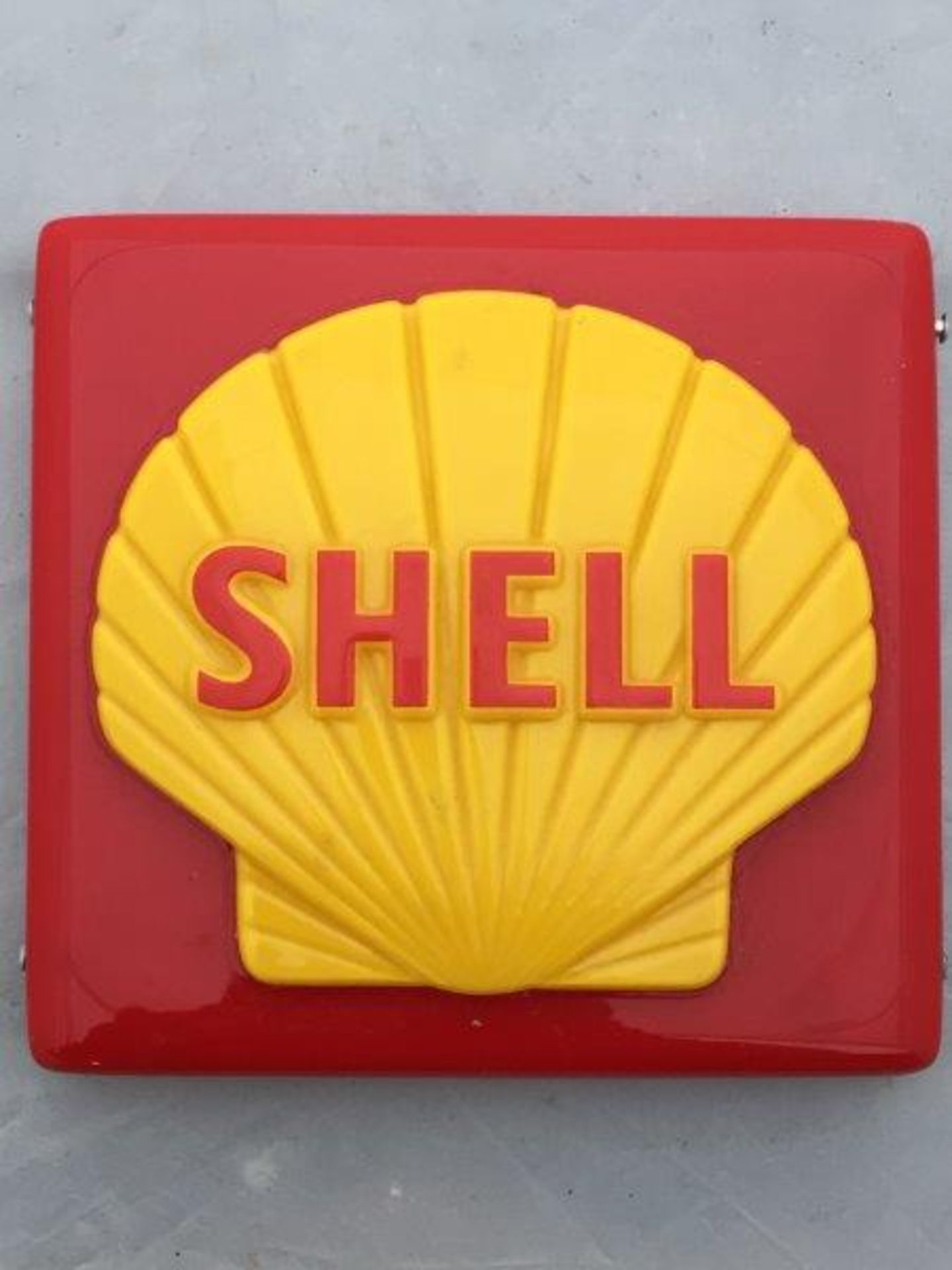 A new old stock Shell plastic petrol pump brand indicator.