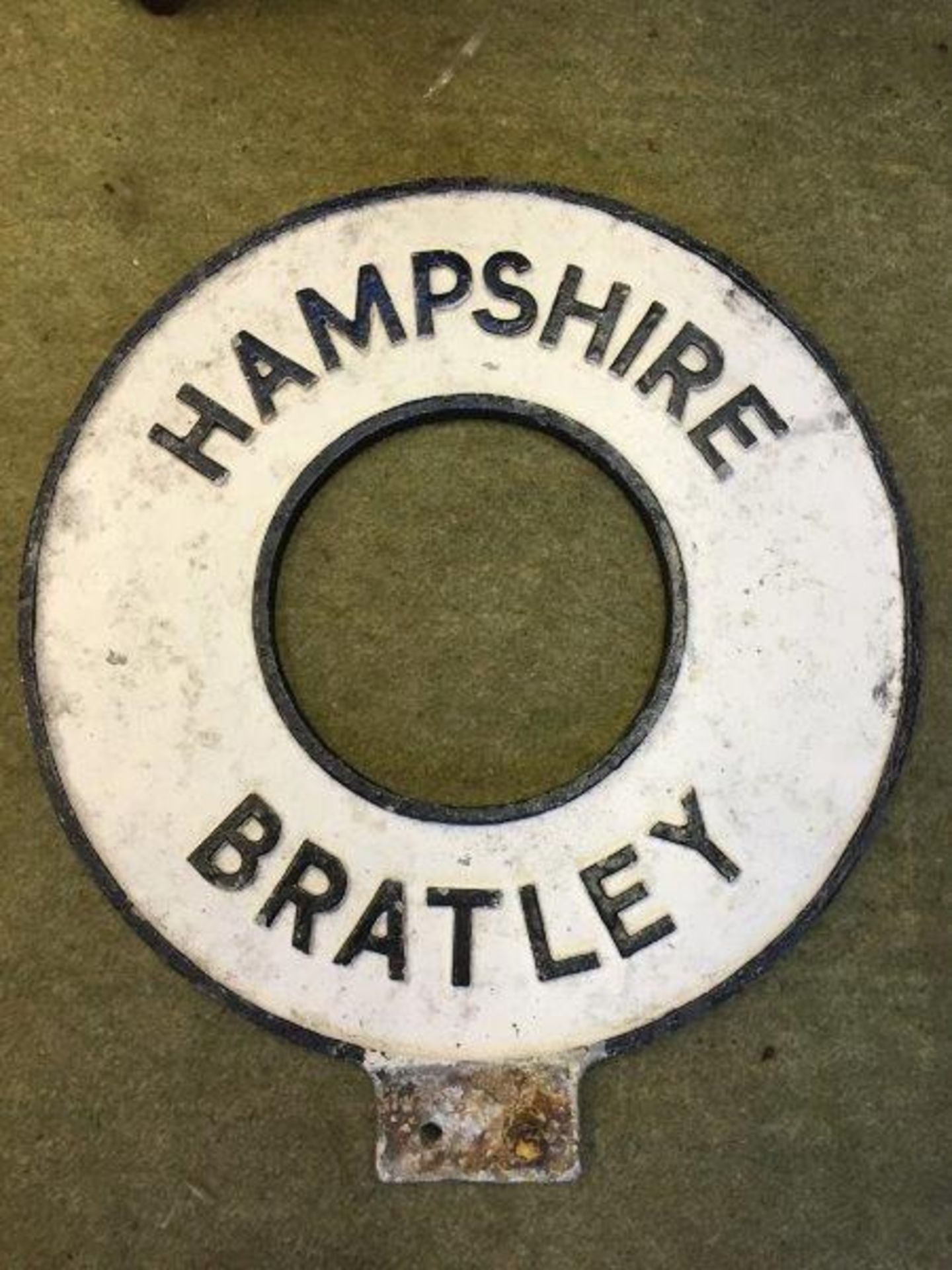 A circular cast aluminium village green sign for Bratley of Hampshire, 15" diameter.