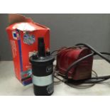 A brand new boxed ignition coil and an unusual six volt emergency ignition coil.