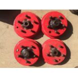 Four cast iron brake drums with integral hubs, possibly MG.