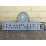 A cast aluminium county road sign - Hampshire, with coat of arms above, 45 x 18 3/4".