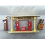 An Esso diecast filling station, an early Shell lead petrol pump and a small bottle of Shell