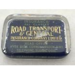 A Road Transport and General Insurance Limited glass paperweight.