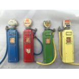 A set of four miniature diecast petrol pumps with globes and original labels for Regent, Shell, BP