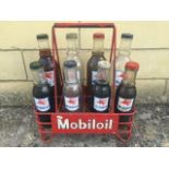 A Mobiloil eight bottle oil crate with eight Mobiloil bottles, different grades.