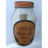 A Shell Motor Oil SAE30 glass jar with original lid.