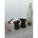 A Essolube glass oil bottle, a Lucas Battery Filler glass bottle and two early oil measures.