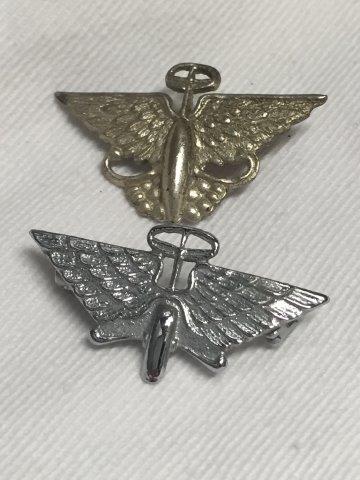 An early Austin Wings and Wheels lapel badge and one later example.