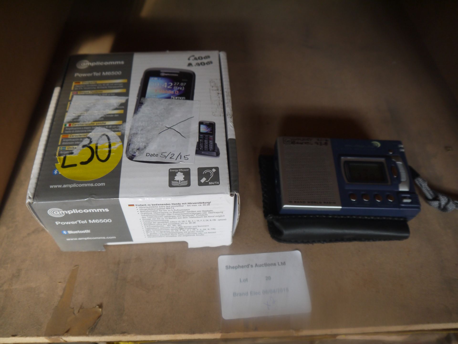 2 item lot that includes a Amplicomms M6500 mobile phone and a small pocket radio