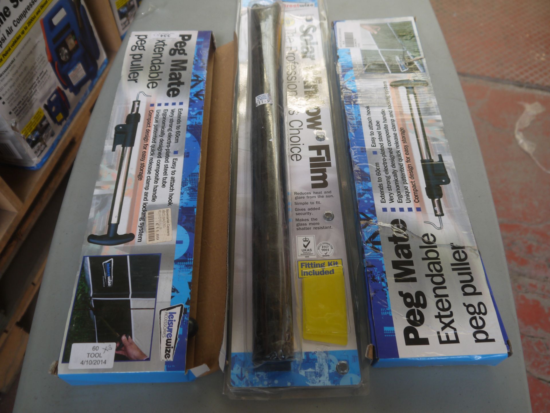 3x Items being a Roll of Tinted window film and 2 extendable tent pug pullers