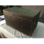 BRASS STUDDED BLACK TRUNK, SIDE HANDLES AND FLORAL PAPER LINING, 745 X 425 X 420