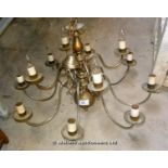 A TWO TIERED 12 BRANCH METALWORK CHANDELIER WITH TURNED AND BULBOUS SUPPORTS AND SCROLL ARMS