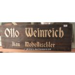 SCREEN USED ADVERTISING SIGN 'OTTO WEINREICH BAU MOBELTISCHLER' (AS USED IN THE 2014 MOVIE 'FURY'