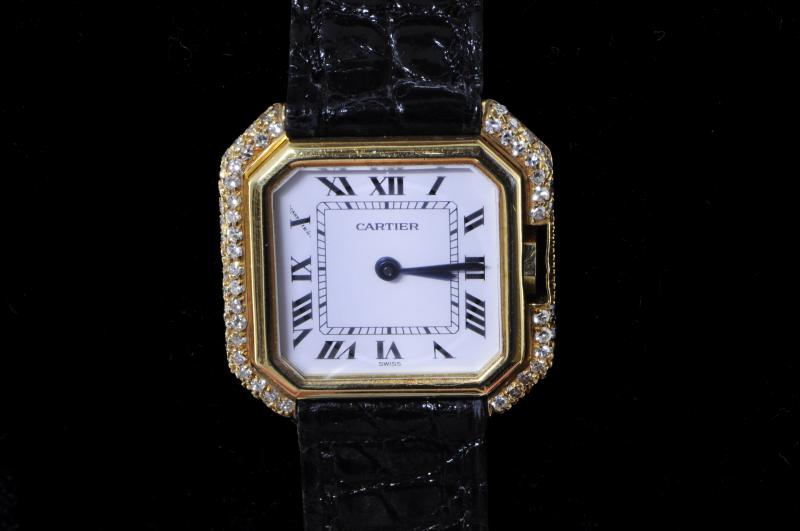 Ladies' Cartier wristwatch, after set diamond bezel, 18ct yellow gold case and buckle on a black