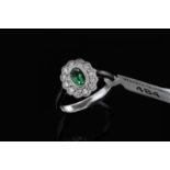 Emerald and diamond cluster ring, central oval cut emerald weighing an estimated 0.42ct,