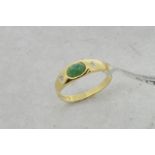 Emerald and diamond ring, central oval cabochon cut emerald with a Swiss cut diamond to each side