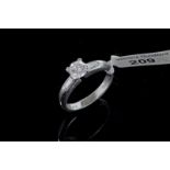 Single stone diamond ring with diamond set shoulders, central round brilliant cut diamond weighing