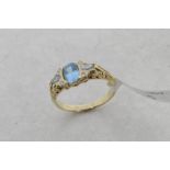 Blue topaz and diamond ring, central oval cut blue topaz, set in between two pear cut blue topaz and