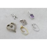 Selection of six pendants, including a diamond set 'kiss' pendant in white metal stamped 9ct,