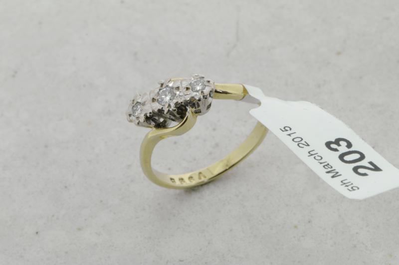 Three stone diamond twist ring, three round brilliant cut diamonds, mounted in 9ct yellow and