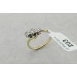 Three stone diamond twist ring, three round brilliant cut diamonds, mounted in 9ct yellow and