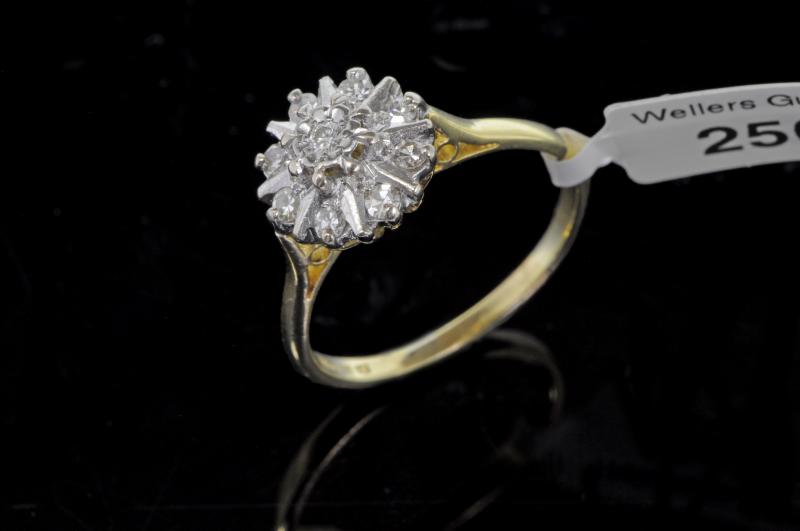 Diamond cluster ring, central round brilliant cut diamond, surrounded by eight Swiss cut diamond,