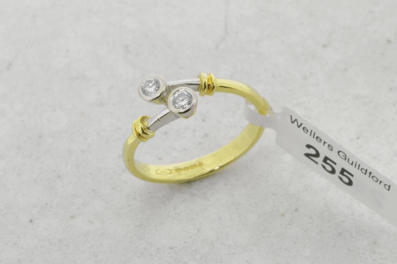 Two stone diamond twist ring, two round brilliant cut diamonds, mounted in 18ct yellow and white