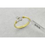 Two stone diamond twist ring, two round brilliant cut diamonds, mounted in 18ct yellow and white