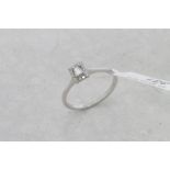 Diamond cluster ring, central step cut diamond, surrounded by round brilliant cut diamonds,