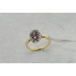 Red tourmaline and diamond ring, central rectangular step cut red tourmaline surrounded by old cut