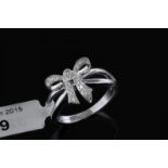 Diamond set bow ring, round brilliant cut diamonds set in a bow motif, mounted in 9ct white gold,