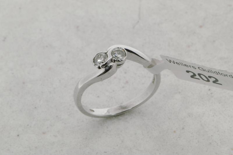 Two stone diamond twist ring, two round brilliant cut diamonds, mounted in 9ct white gold, ring size