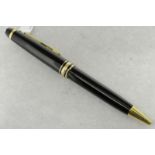 Montblanc Meisterstuck Classique ballpoint pen, black pen with gold plated detail, surmounted by the