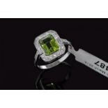 Peridot and diamond ring, emerald cut peridot weighing an estimated 3.00ct, surrounded by round