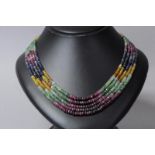 Gem set beaded necklace, five strands of multicoloured gem beads including rubies, emeralds and