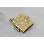 Holy Bible charm, opening to reveal various pages containing texts, engraved cover, in 9ct yellow
