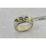 Emerald and diamond ring, central oval cut emerald with a pear cut emerald to each side, with a line